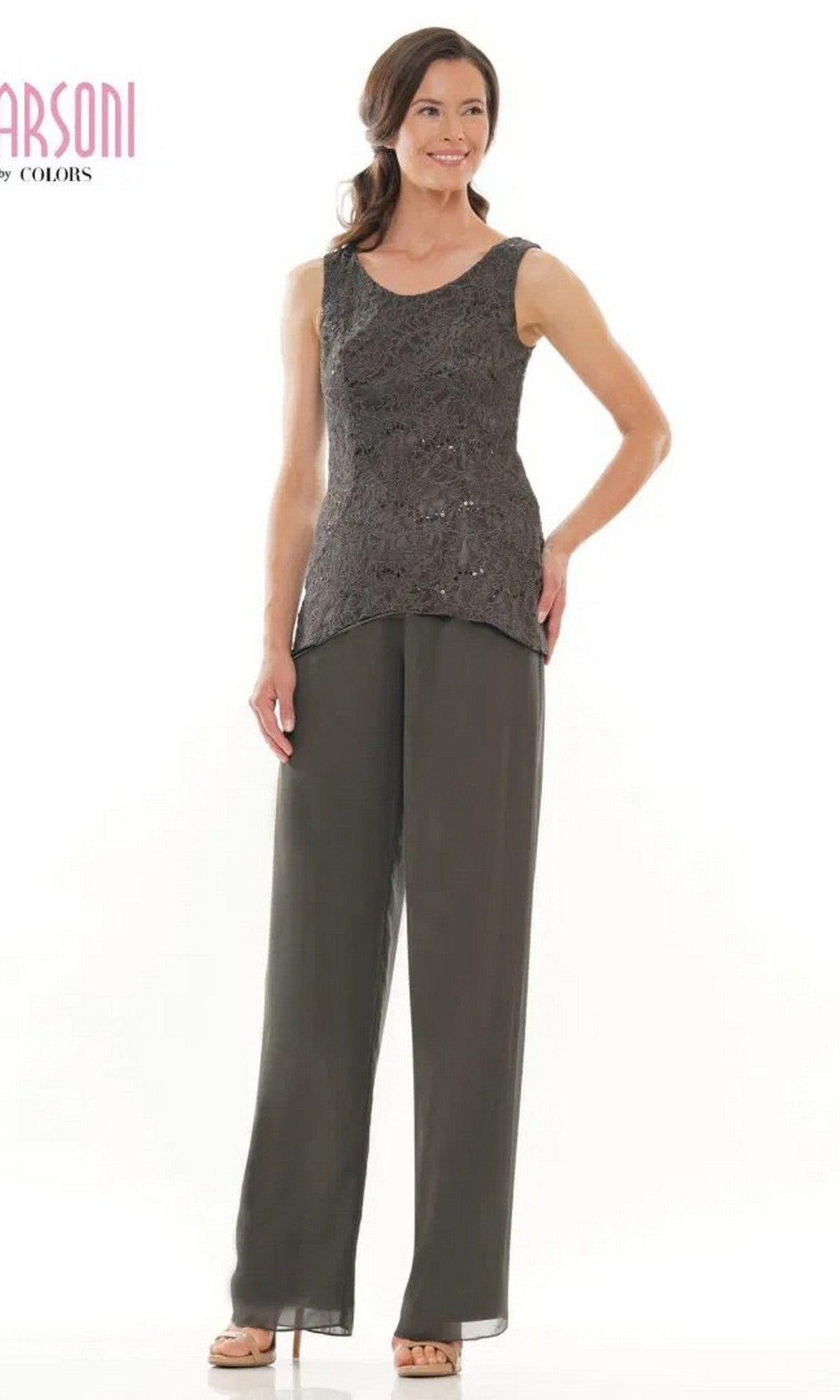 A woman smiles with one hand on her hip, modeling the Marsoni M303 long formal pantsuit—sleeveless lace top with wide-leg trousers—against a plain white background.